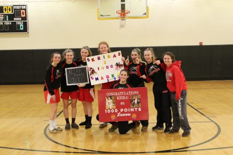 Marks celebrating her 1,000 point with her fellow teammates. 
