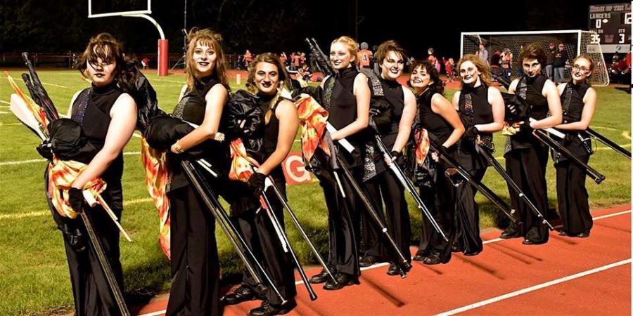 The color guard, in full uniform and makeup, ready to take the field. 