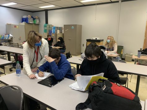 On Mondays, Ms. Pam Herzig (front left) and Ms. Donna Hess (back right) work with students on their math assignments. 