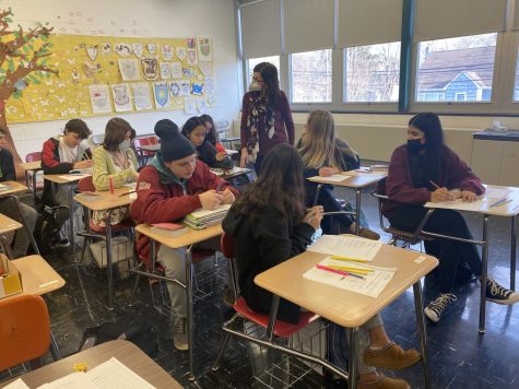 Ms. Ann Pagano, English teacher, teaches to a class of  students now having the choice on whether to wear a mask or not.