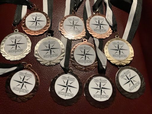 Just like how the girls shine in the water, their conference medals shine for everyone to see as well!
