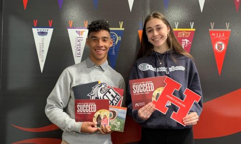 Juniors Divine Crilly and Melissa Meakem show off their swag from the College and Career Fair hosted by LRHS on April 8.