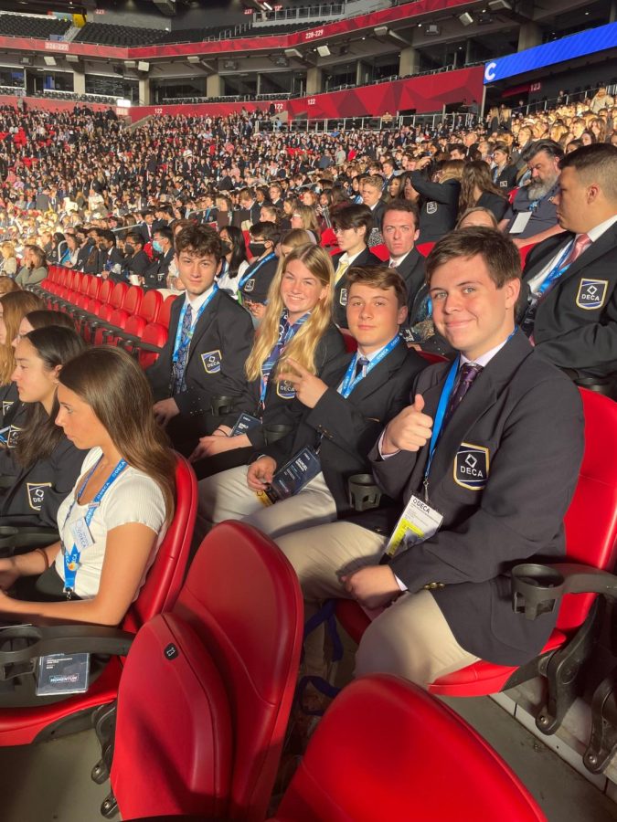 DECA participants giving a thumbs up towards nationals.