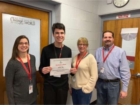 Sebastian Palmer with Mr. Mulhern, Ms, Fagan, and Ms. Bronstein holding his nomination.