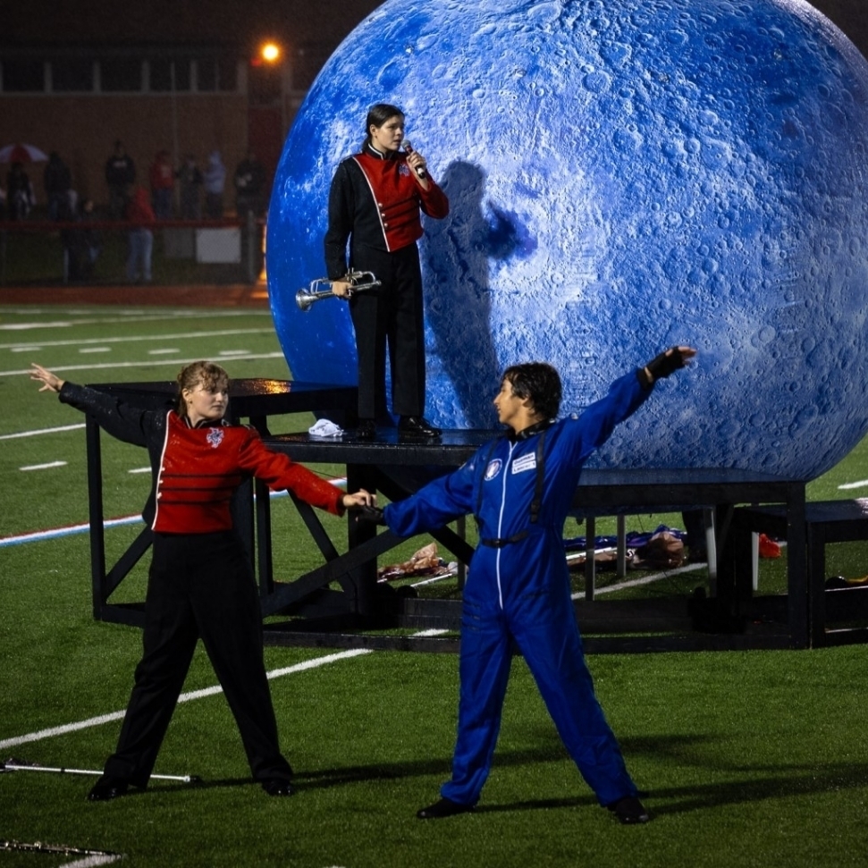 The Lancer band and color guard performing their show during haltime of a varsity football game. 

(Courtesy of the Lake Live Feed)