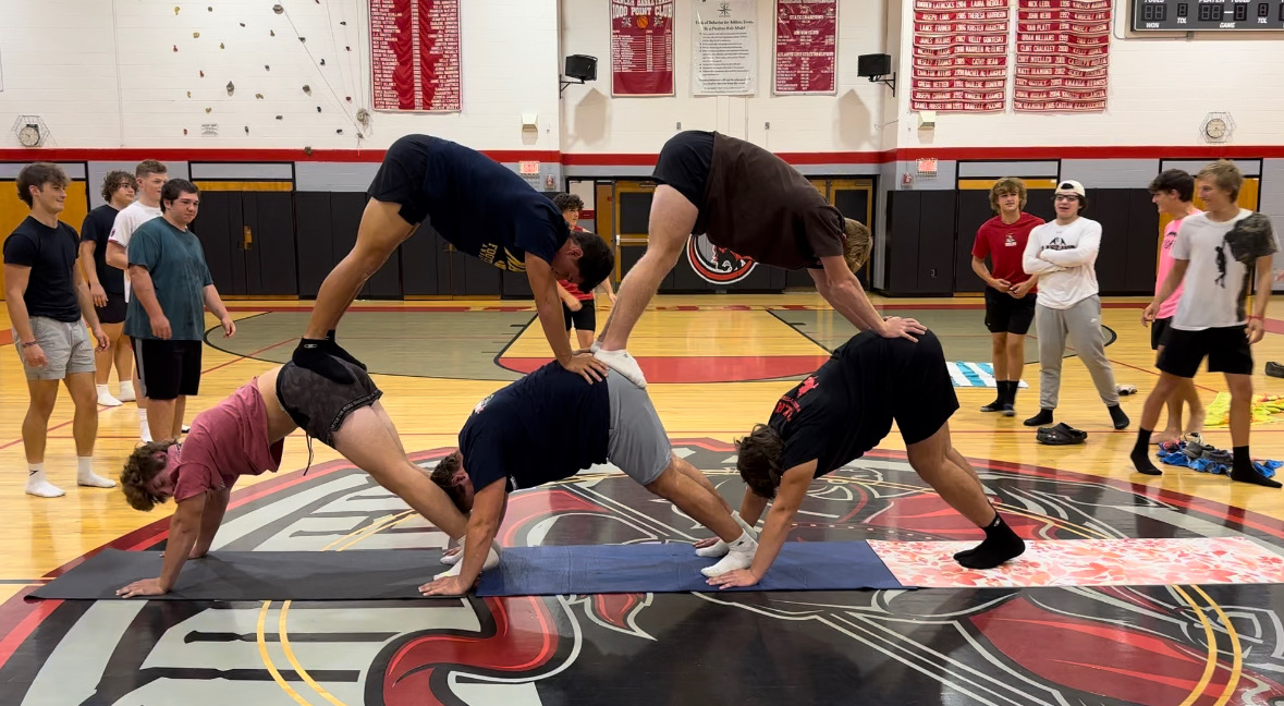 Ms. Gentile led the players in team building yoga, creating a yoga pyramid.

(Courtesy of Ms. Gentile)