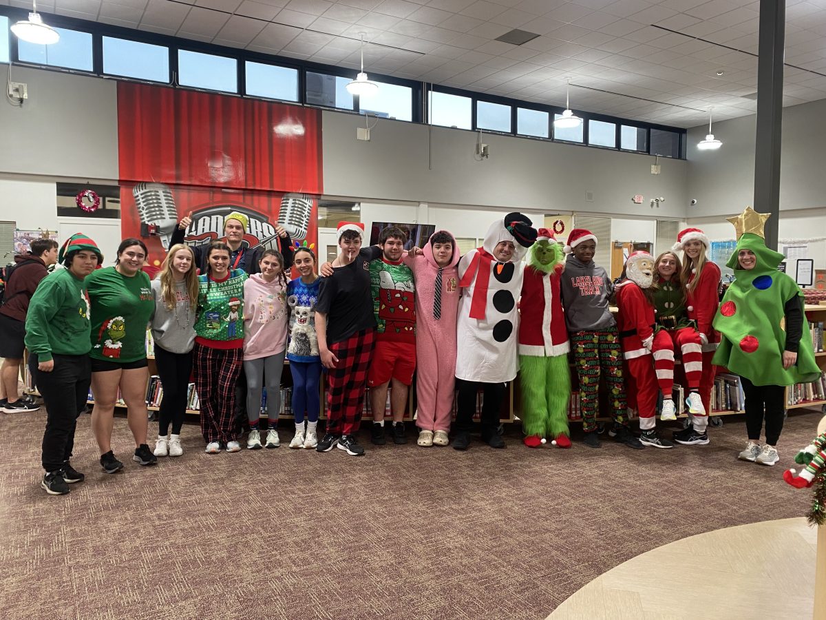 The Lakeland Lancers Winter Track team shows off their costumes for their annual holiday gift wrapping practice.