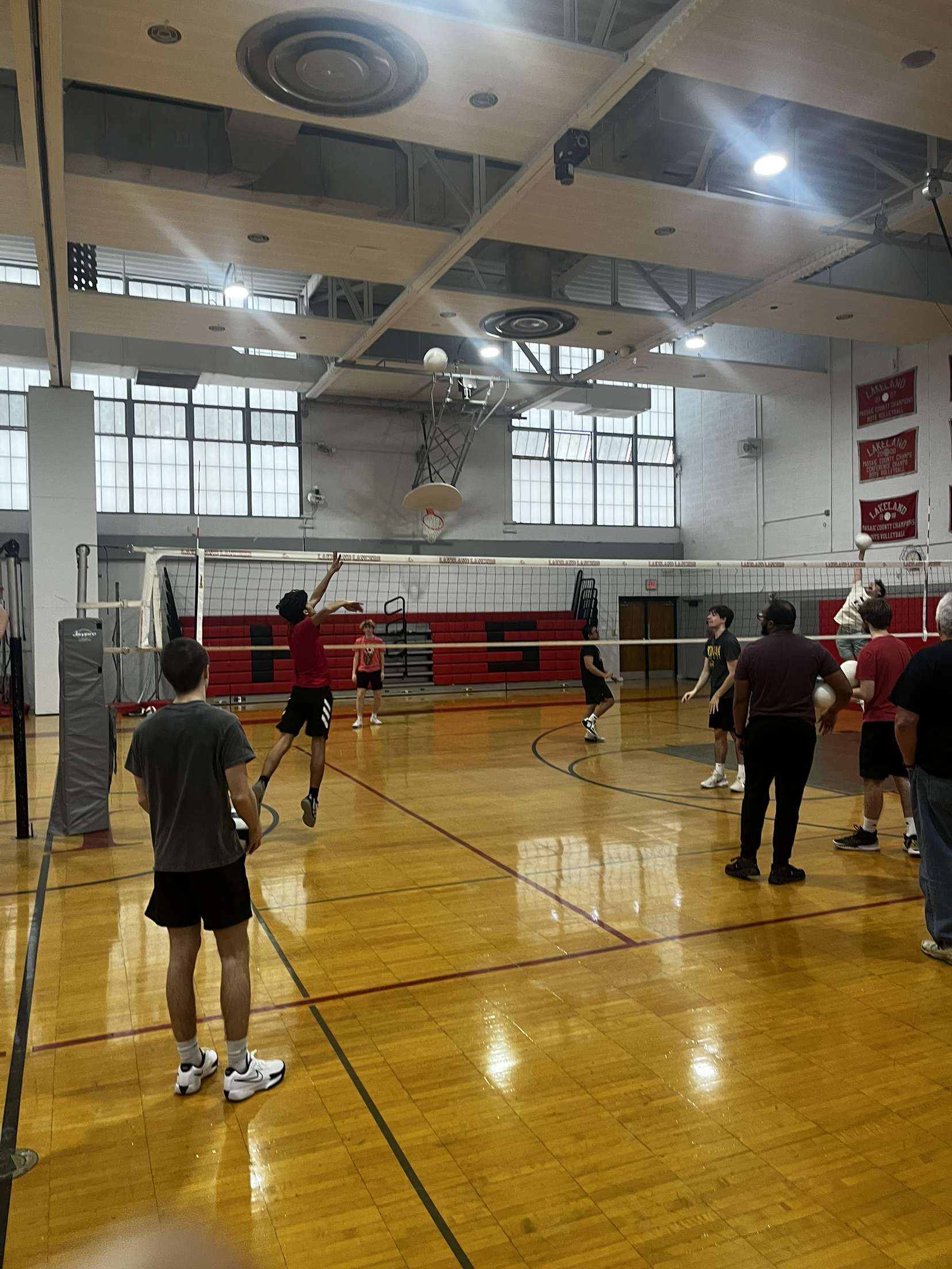 The boys volleyball team, pictured here, can be seen warming up their hands with a number of team activities.