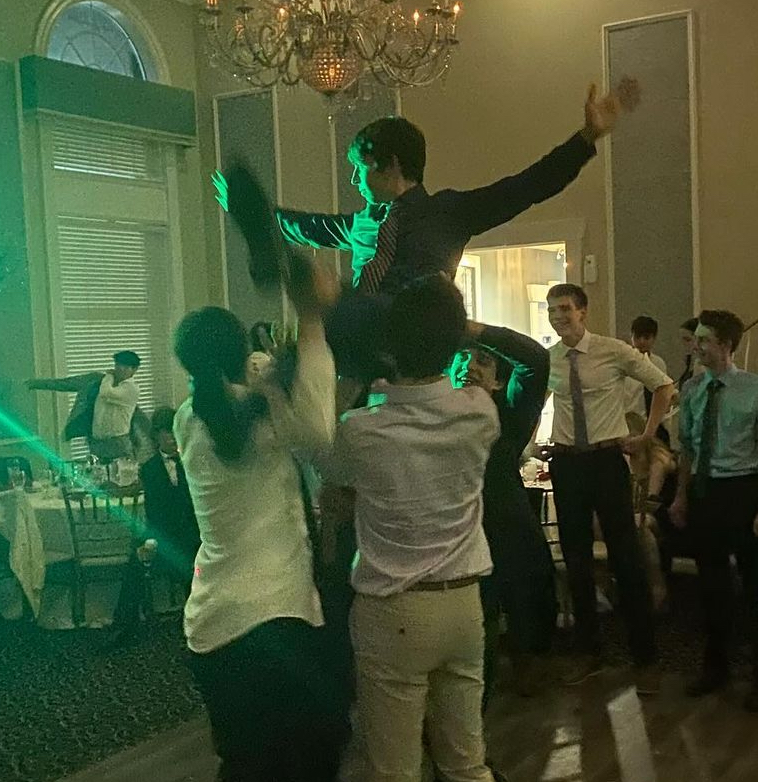 Behind the scenes! Junior Luke Krafton gets lifted up above the dance floor.