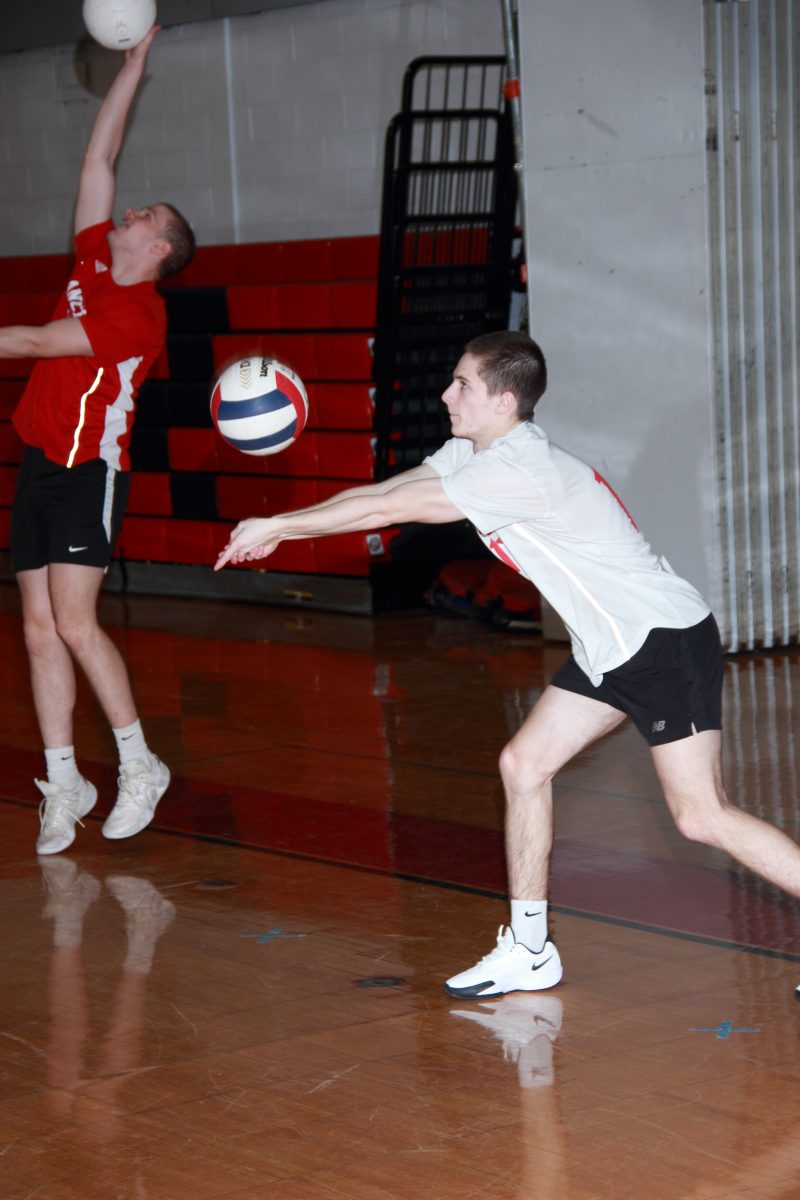 The varsity boys volleyball team pose for a photo.