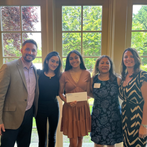 Diya (middle) with her family, Assistant Superintendent Mr. Novak, and counselor Ms. Matlosz when presented with the award.