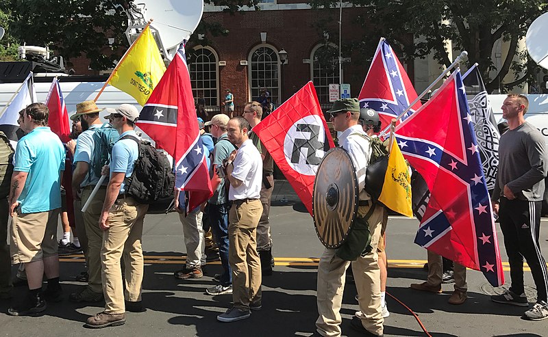 Far-right protesters preparing to enter Emancipation Park holding Nazi, Confederate, and libertarian flags. Photo was taken during the Charlottesville "Unite the Right" rally in 2017.

(Anthony Crider; cropped by Beyond My Ken (CC BY 2.0))