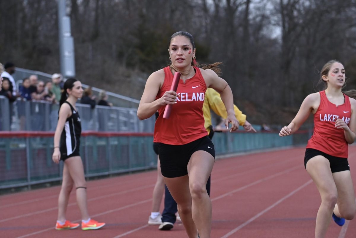 Setti recieves the baton to lead the 4x400 meter relay to victory.

(LRHS)