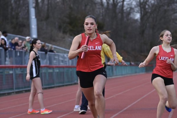 Setti recieves the baton to lead the 4x400 meter relay to victory.

(LRHS)