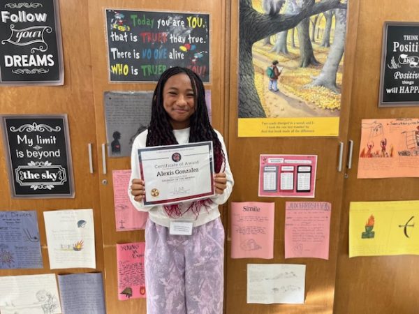 Freshman Alexis Gonzalez proudly displays her Student of the Month award for social studies. 

Photo courtesy of Ms. Laura Fucilli 