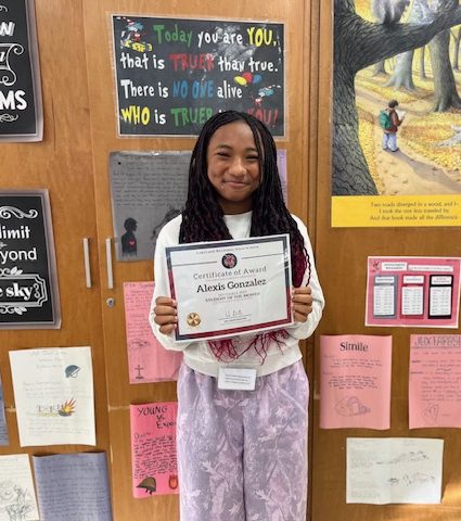 Freshman Alexis Gonzalez proudly displays her Student of the Month award for social studies. 

Photo courtesy of Ms. Laura Fucilli 