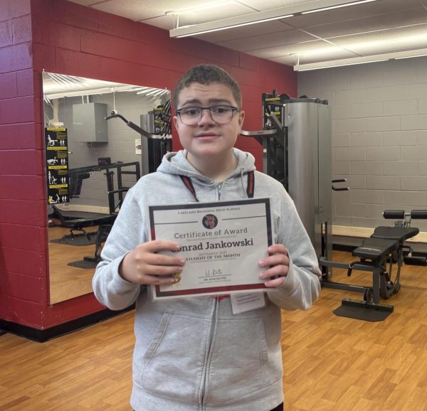 Conrad Jankowski proudly displays his Student of the Month Award. 

Photo courtesy of Amelia Elligque-Bustos 