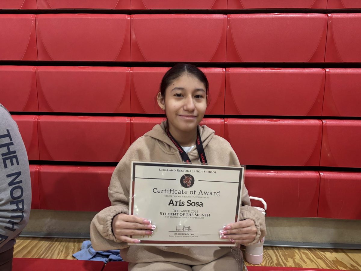 Aris Sosa poses with her Student of the Month Award for her involvement in the CORE program. 

Photo courtesy of Amelia Bustos Elligque 