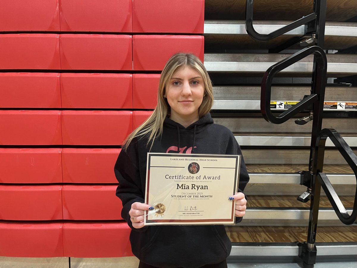Mia Ryan accepts her award as Student of the Month in Physical Education class. 

Photo courtesy of Ava Radice. 