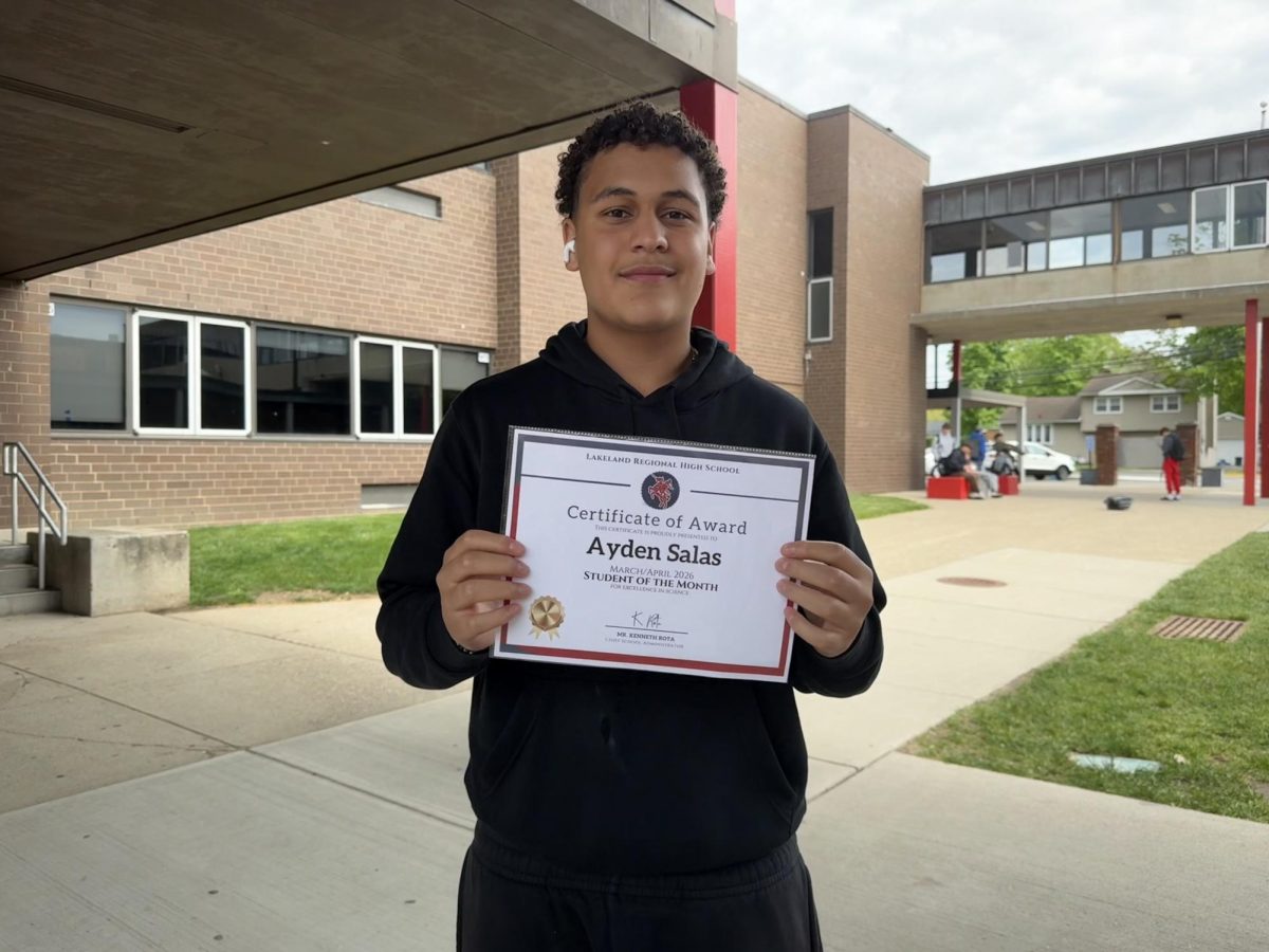 Freshman Ayden Salas proudly displays his student of the month award on the Lakeland greenway. 

Photo courtesy of Kylie Lanou